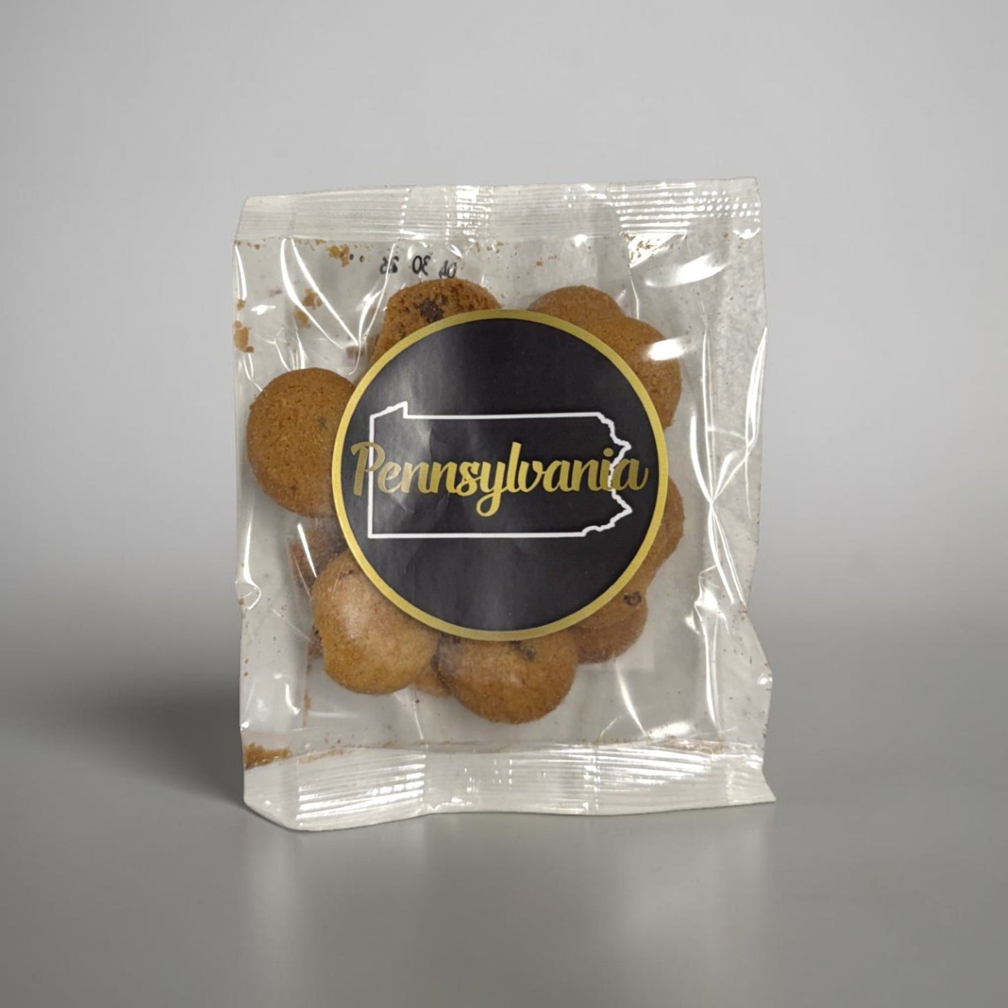 Packaged chocolate chip cookies with a Pennsylvania label on a gray background